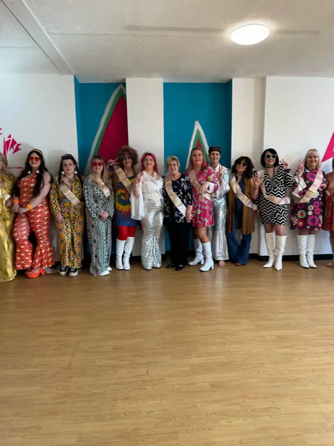 ABBA hen party dance class in Nottingham, group lined up in 70s disco outfits
